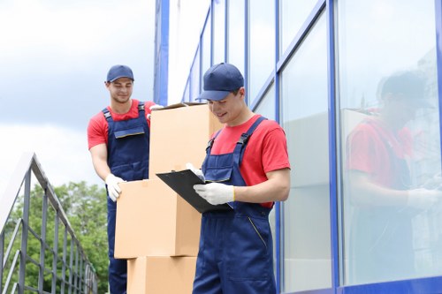 Team carrying furniture through a Shoreditch apartment building