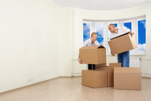 Staff coordinating a safe furniture move in a narrow hallway
