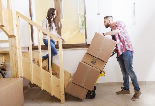 Professional movers navigating a narrow East London access road