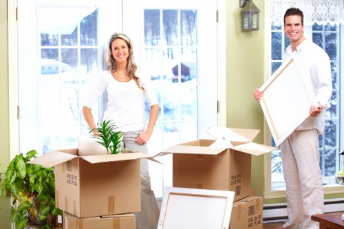Professional movers navigating stairs in a Shoreditch flat conversion